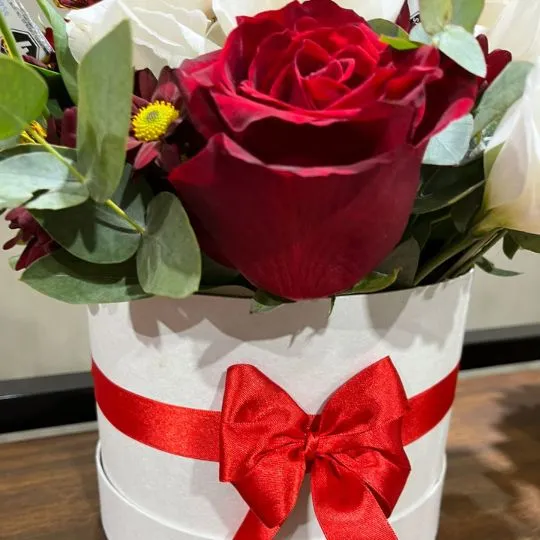 Caja pote con flores de estacion rosas y chocolates 